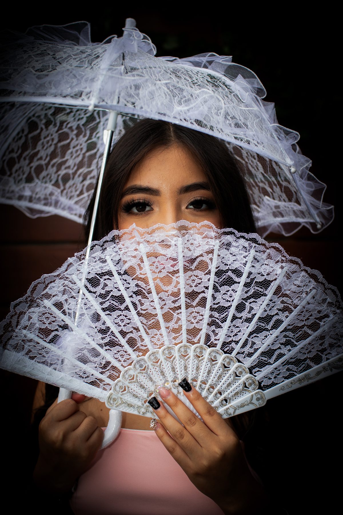Portrait behind a white lace fan